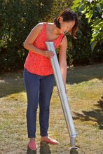 Load image into Gallery viewer, women imserting the main pole of the GARD&ROCK - Hammock Post (428-014) into the ground